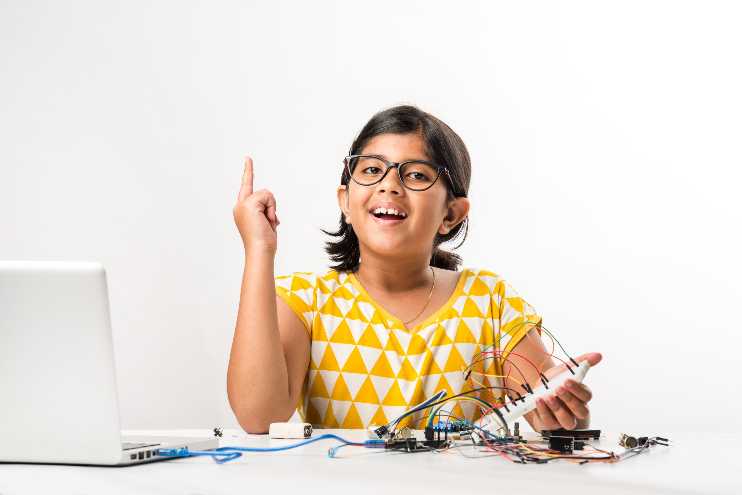 Electronic experiment - Indian girl student working with wires and connections inventing something